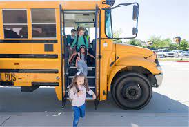 students getting off yellow school bus